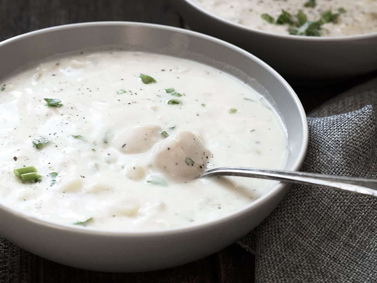 thick and creamy seafood chowder in bowl with spoon