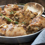 chicken with dijon mustard sauce in pan with spoon