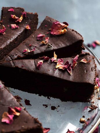flourless chocolate truffle cake sliced with rose petals