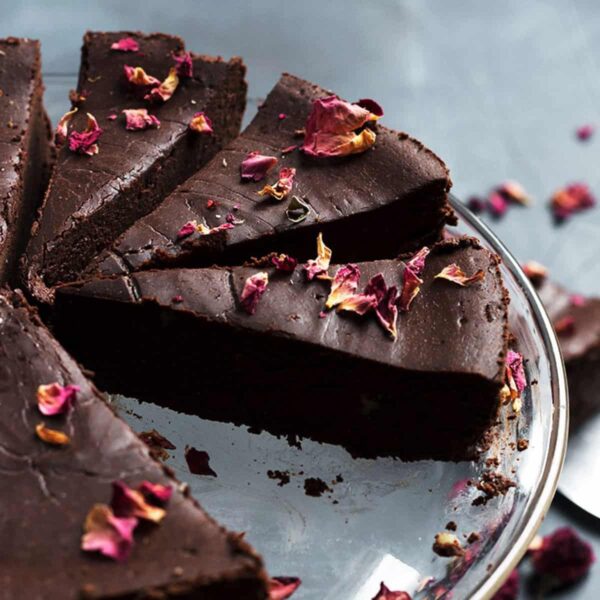 flourless chocolate truffle cake sliced with rose petals