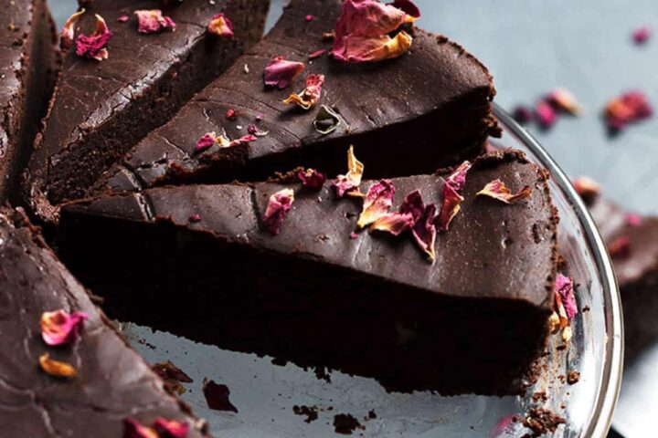flourless chocolate truffle cake sliced with rose petals