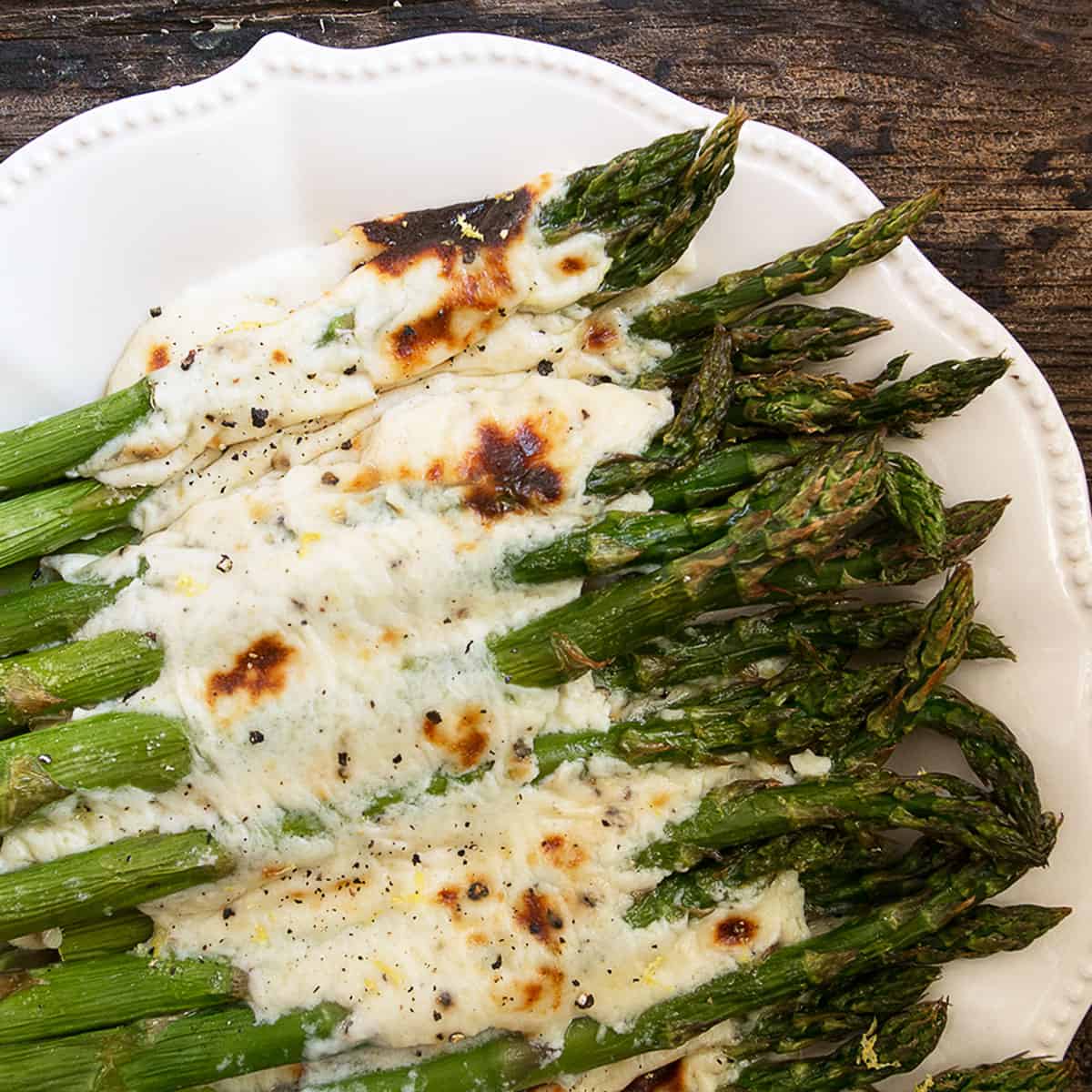Asparagus cacio e pepe on a white serving platter.