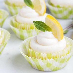 lemon cupcakes with lemon slice and mint sprig on top