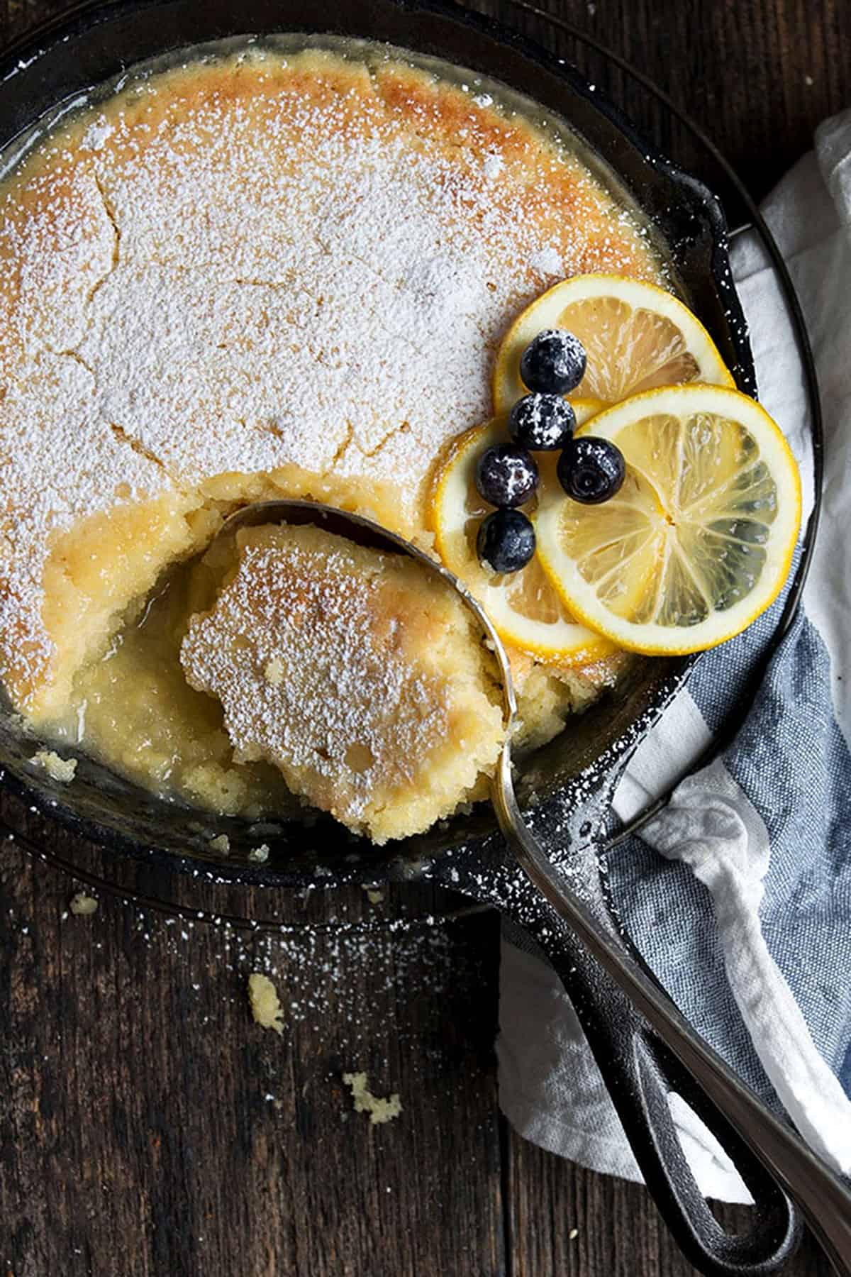 lemon cake and sauce in cast iron skillet