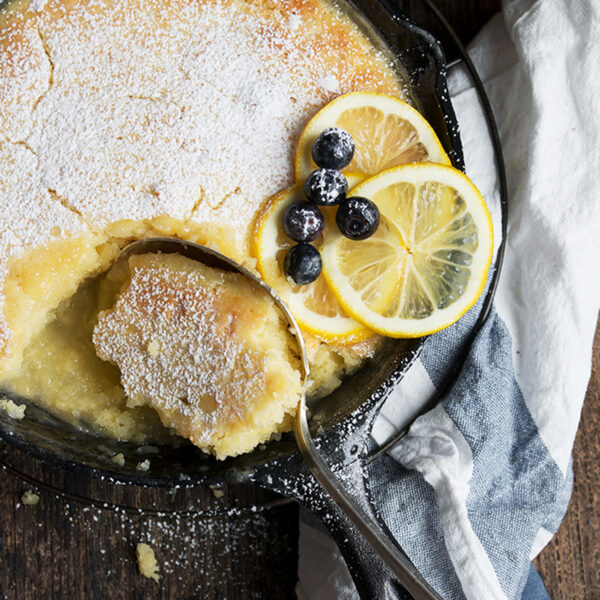 lemon cake and sauce in cast iron skillet