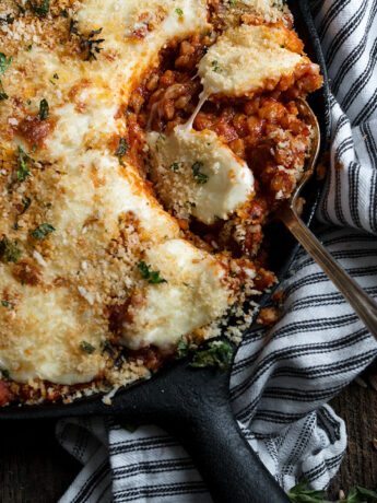 sausage and farro Parmesan in skillet with spoon