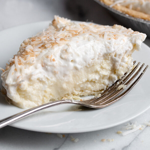 coconut cream pie slice on plate with fork