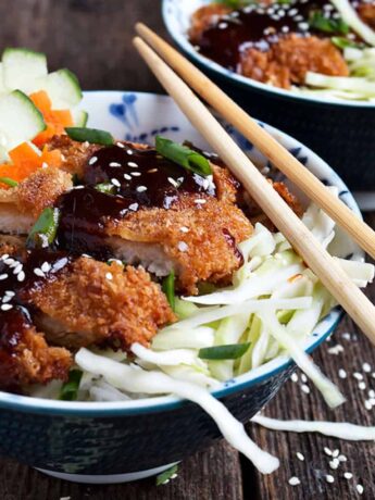 pork katsu rice bowls with chopsticks