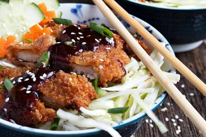 pork katsu rice bowls with chopsticks
