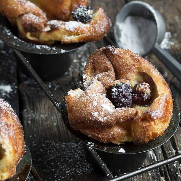 sugar coated popovers with blackberries in popover pan
