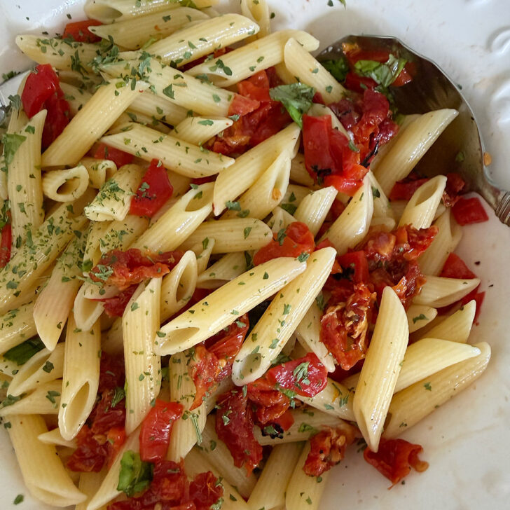 Vegetables mixed with the pasta in the salad bowl.