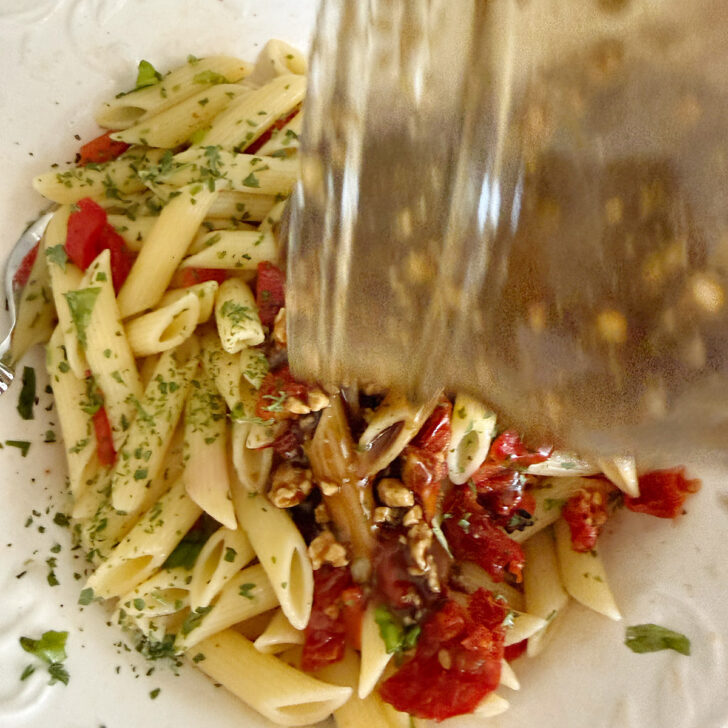 Adding the balsamic dressing to the salad.