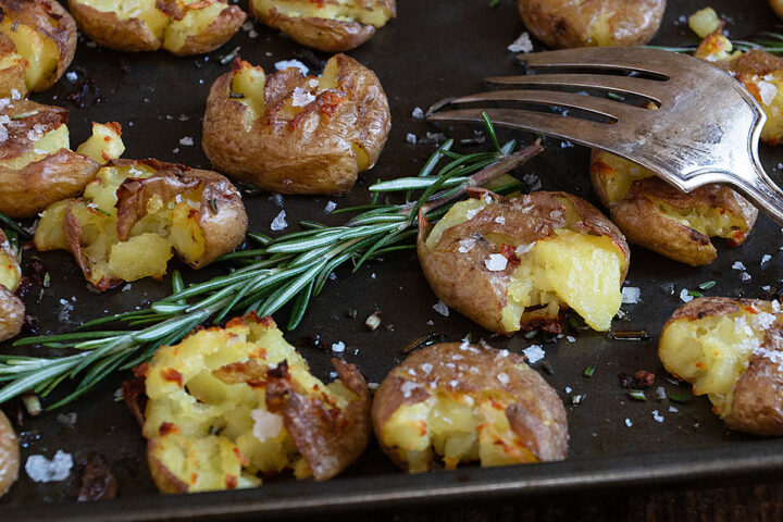 rosemary olive oil smashed potatoes on baking sheet