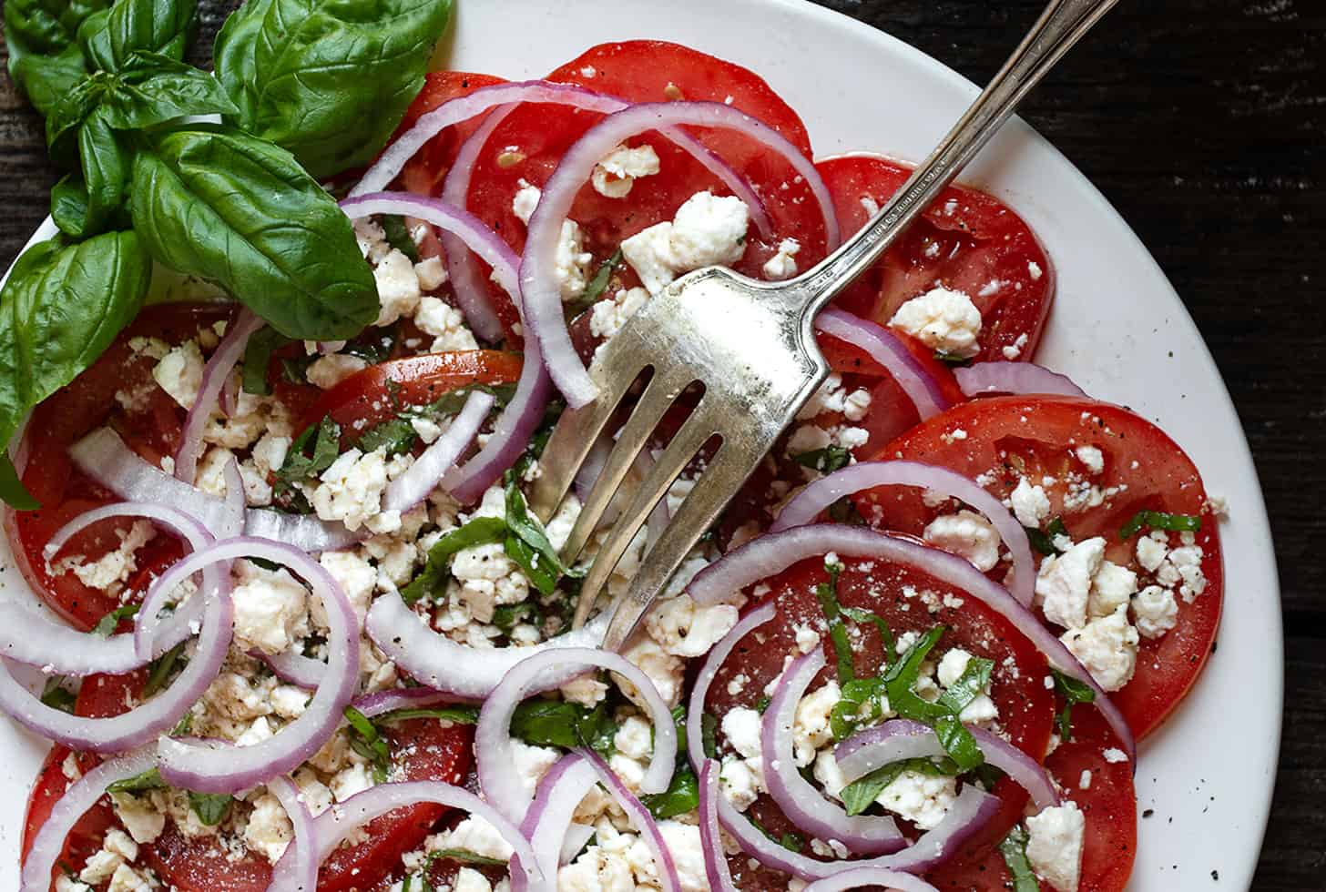 tomato feta salad on white plate