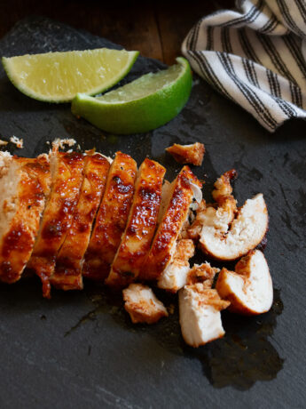 Chili lime chicken sliced on a cutting board.