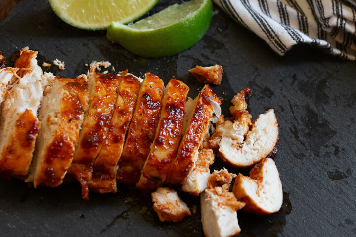 Chili lime chicken sliced on a cutting board.