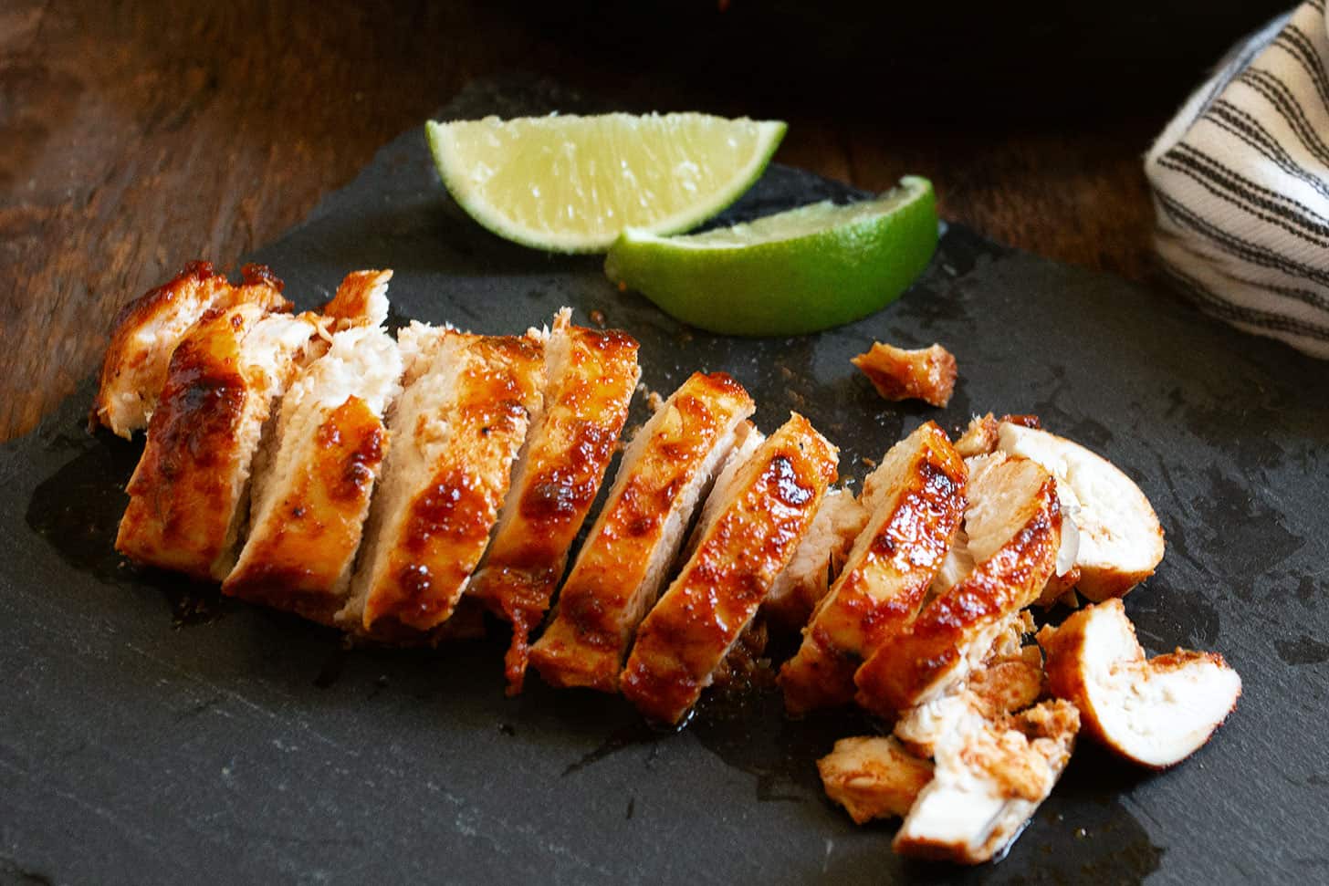 Chili lime chicken sliced on a cutting board.