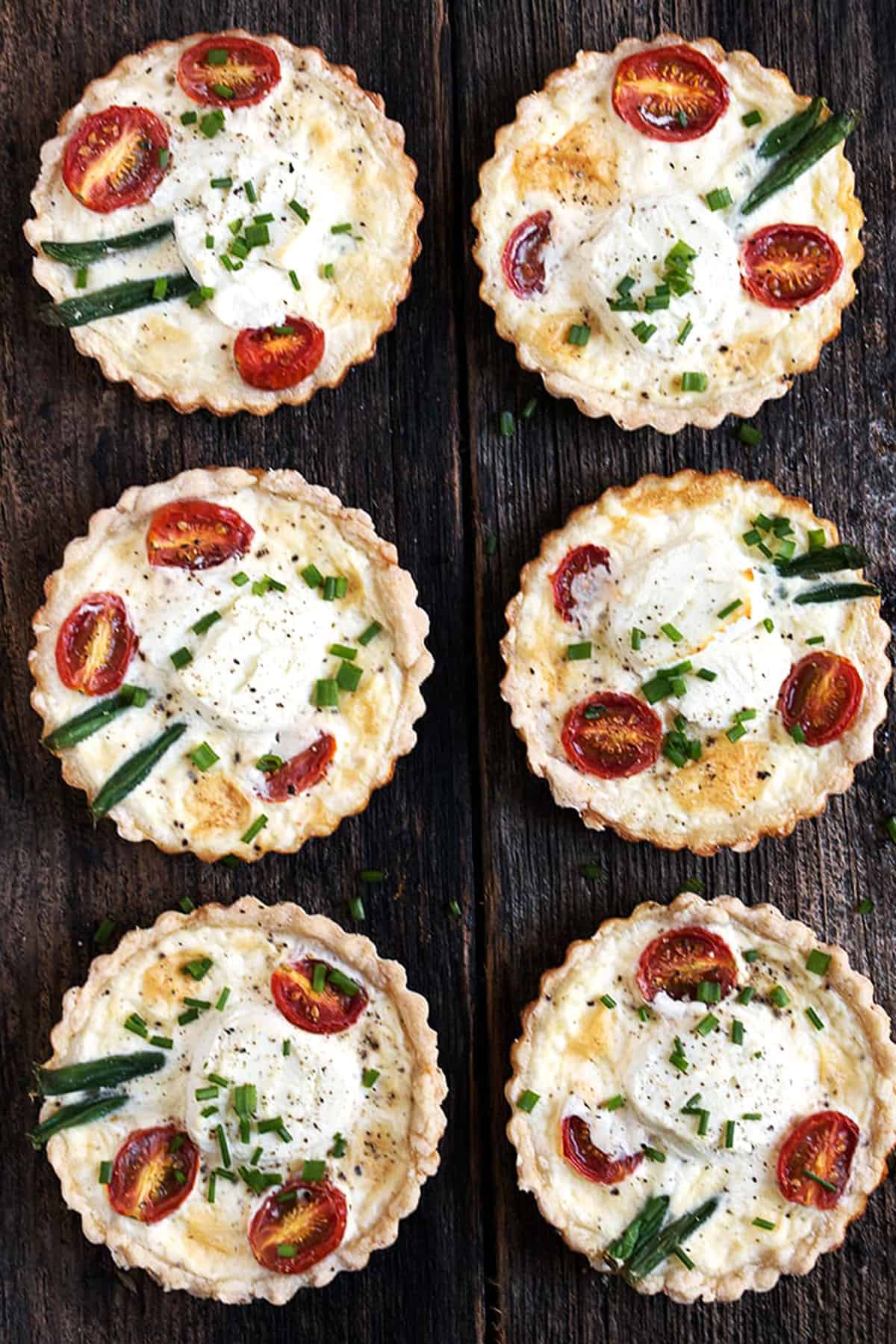 goat cheese tomato tarts on wood background