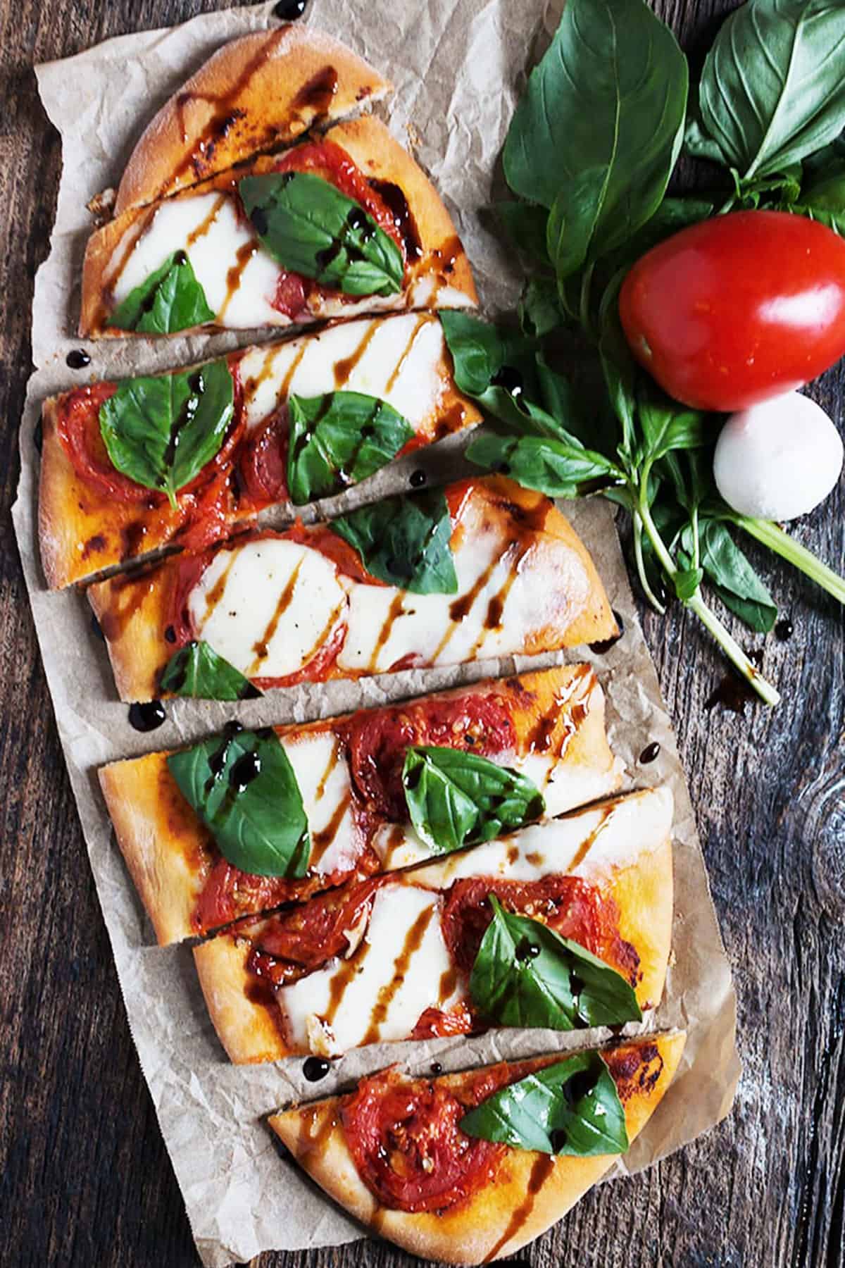 tomato bocconcini flatbread on wood background