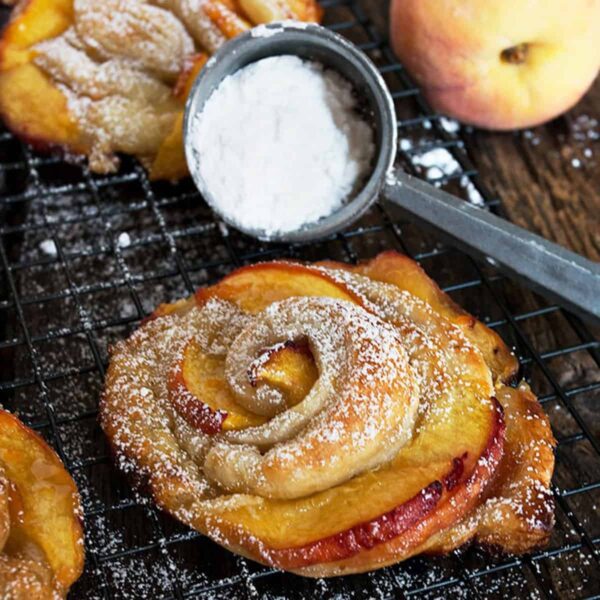 rose-shaped peach puff pastries on cooling rack