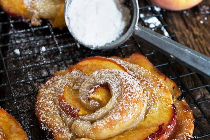 rose-shaped peach puff pastries on cooling rack
