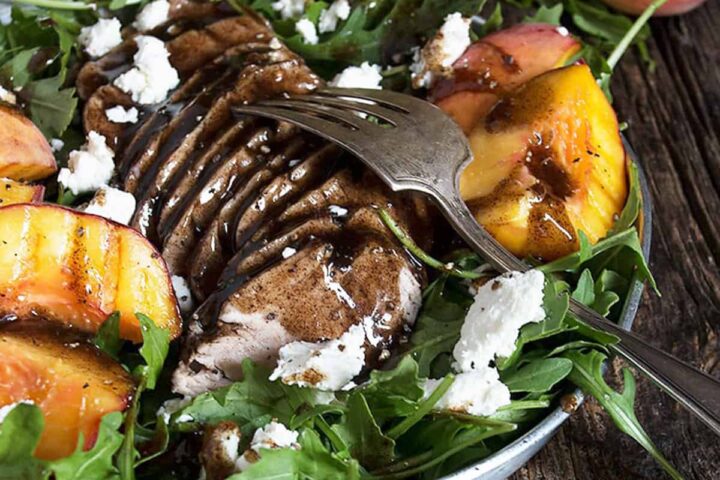 balsamic pork tenderloin and peach salad on platter