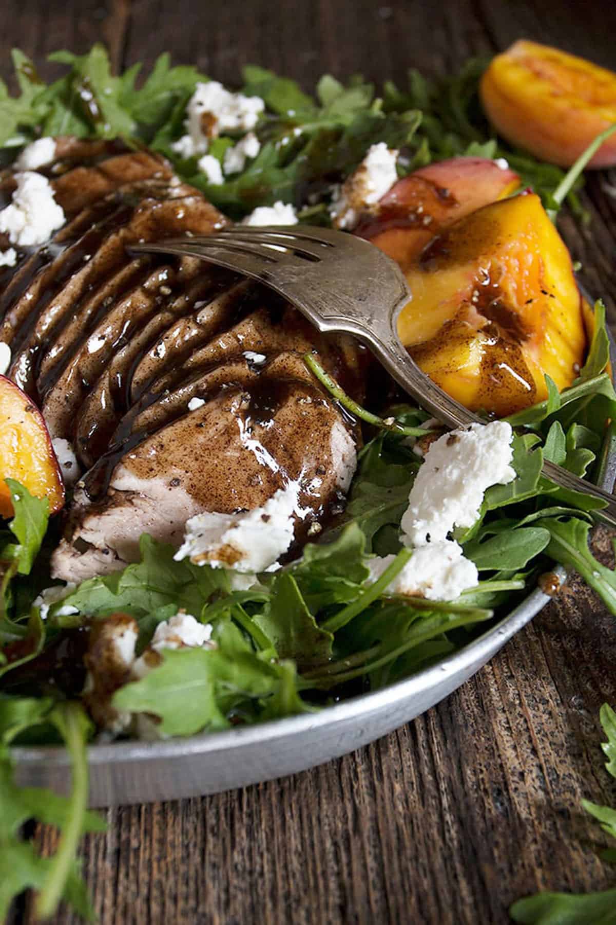 balsamic pork tenderloin and peach salad on platter