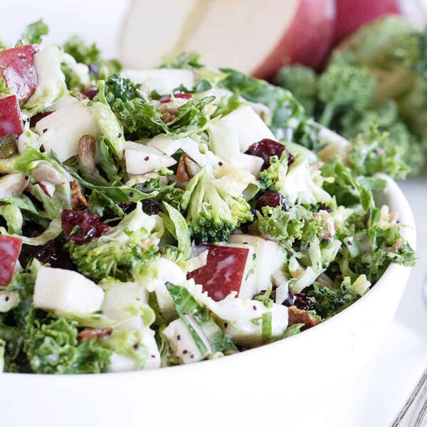 Fall kale salad with apple in white bowl