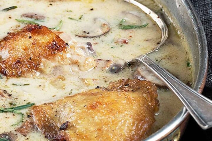 French chicken with creamy sauce in pan with spoon