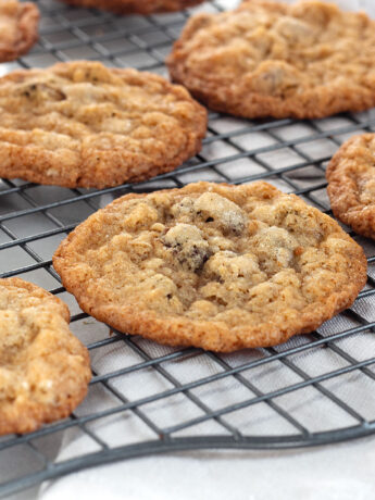 crispy oatmeal chocolate chip cookies on cooling rack