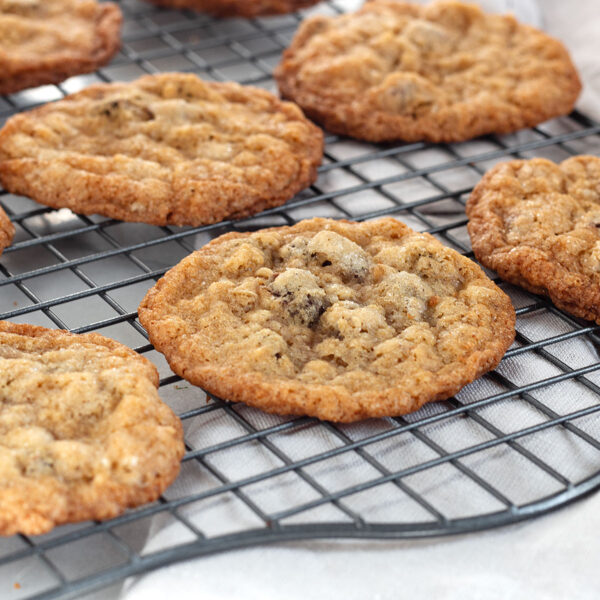crispy oatmeal chocolate chip cookies on cooling rack