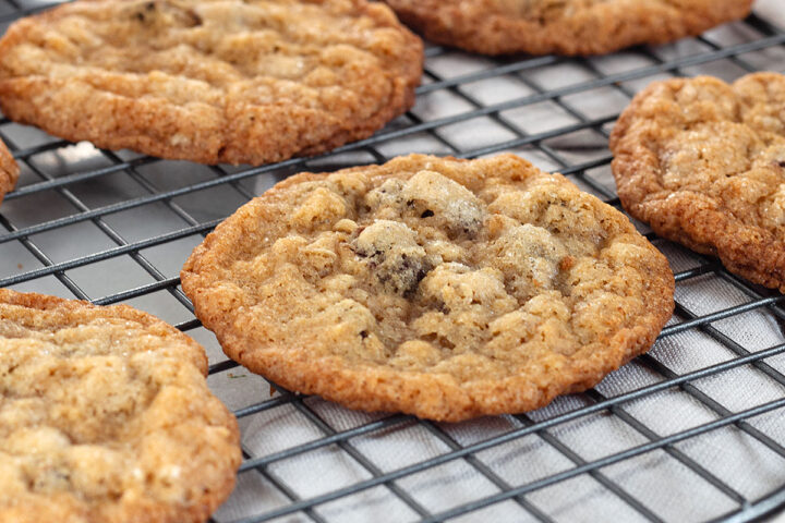 crispy oatmeal chocolate chip cookies on cooling rack