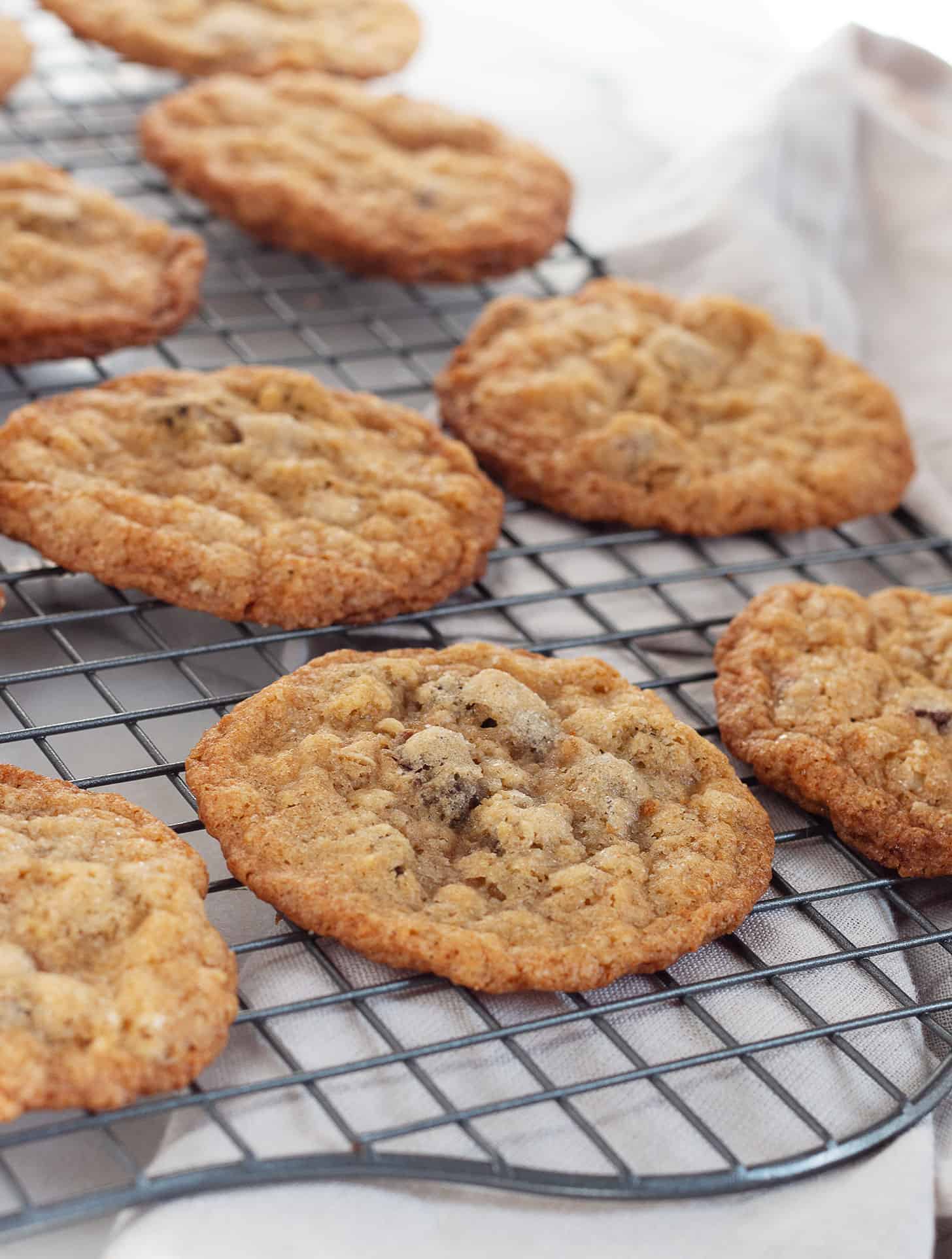 crispy oatmeal chocolate chip cookies on cooling rack