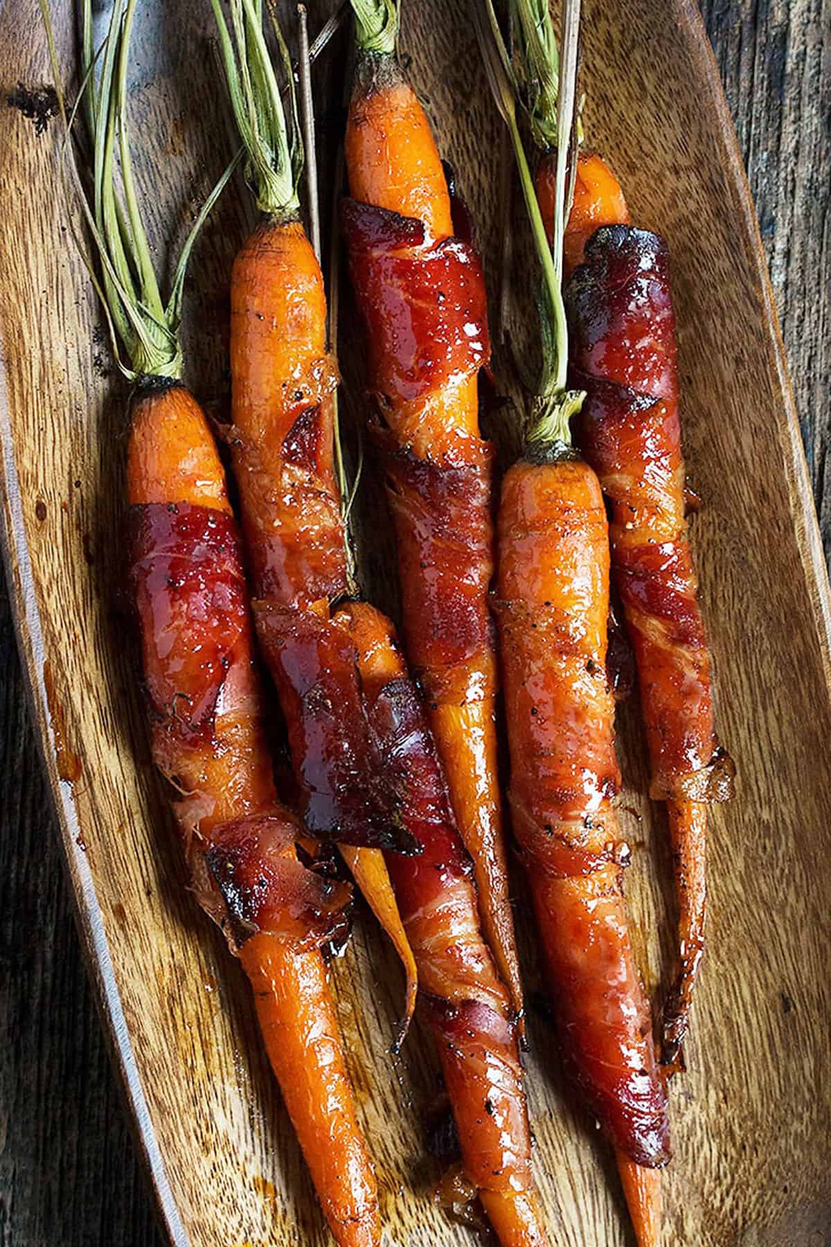 bacon wrapped maple glazed carrots in serving bowl