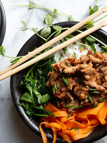 spicy pork rice bowl with chopsticks