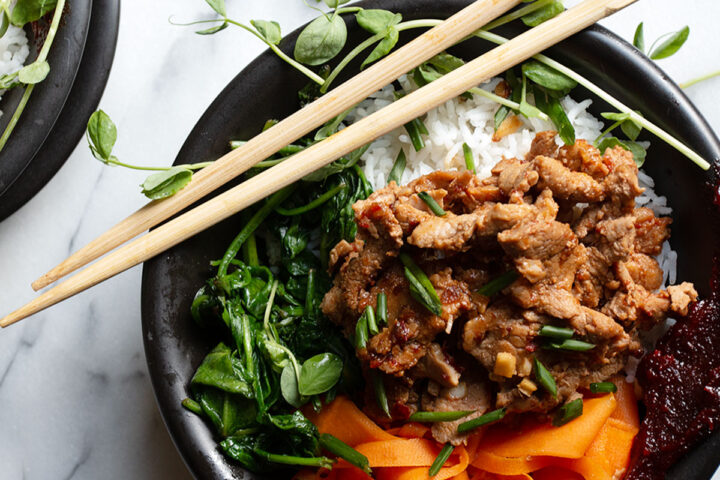 spicy pork rice bowl with chopsticks