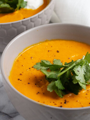 Thai carrot soup with coconut milk in bowl
