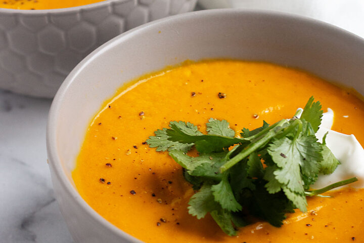 Thai carrot soup with coconut milk in bowl