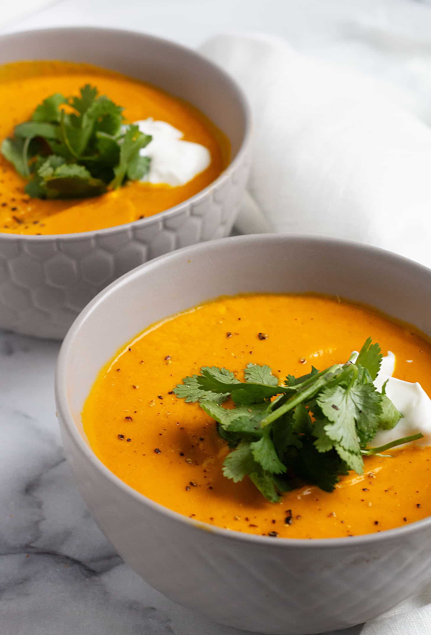 Thai carrot soup with coconut milk in bowl