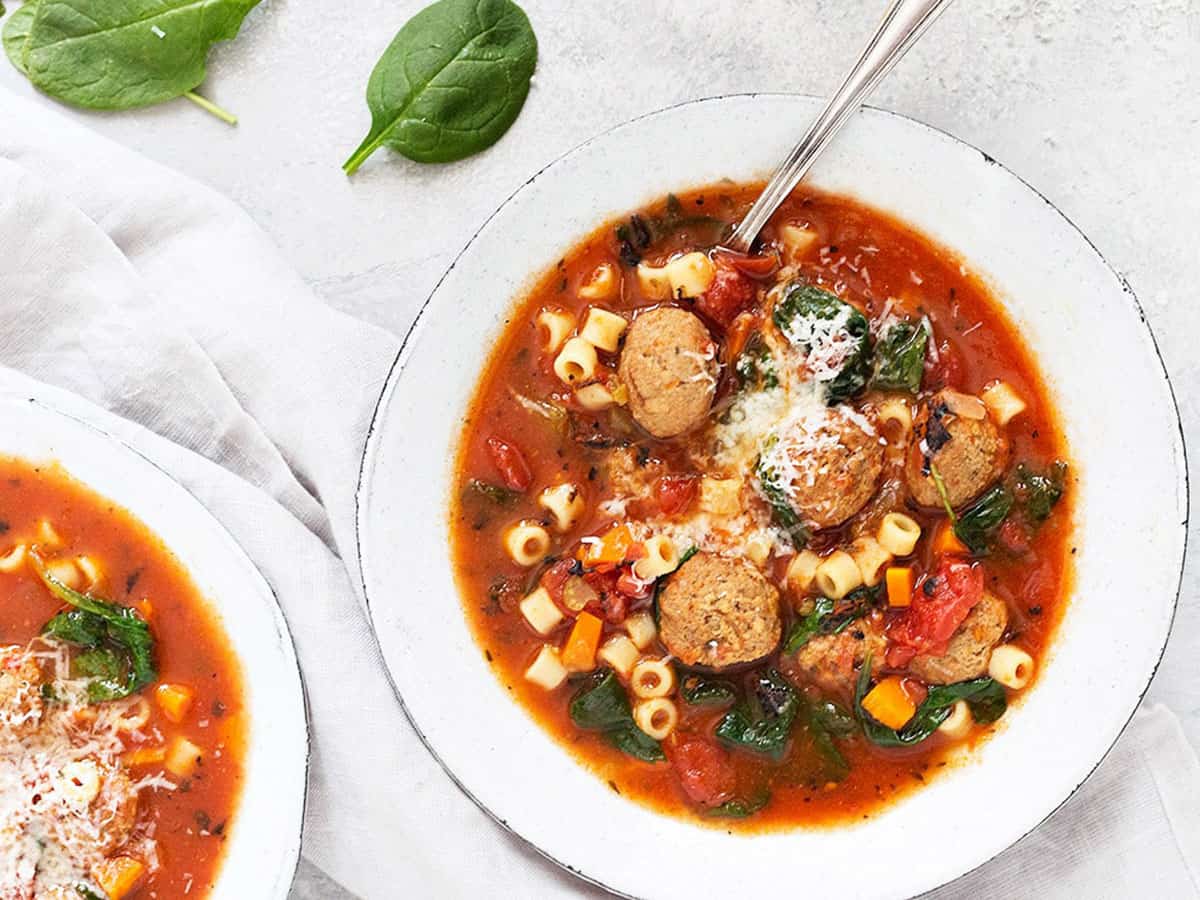 Italian meatball soup in white bowls