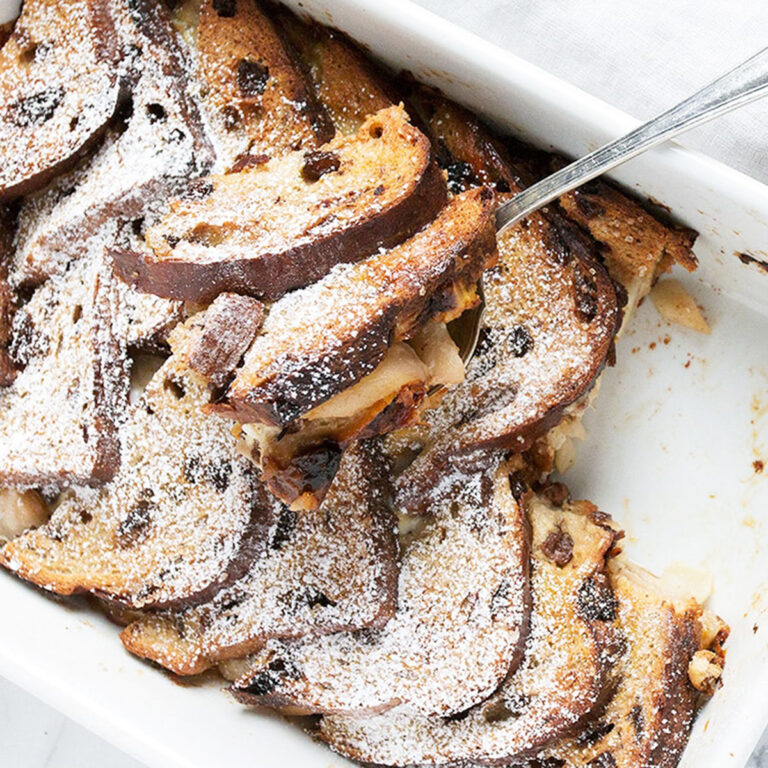 pear gruyere french toast in white baking dish with spoon