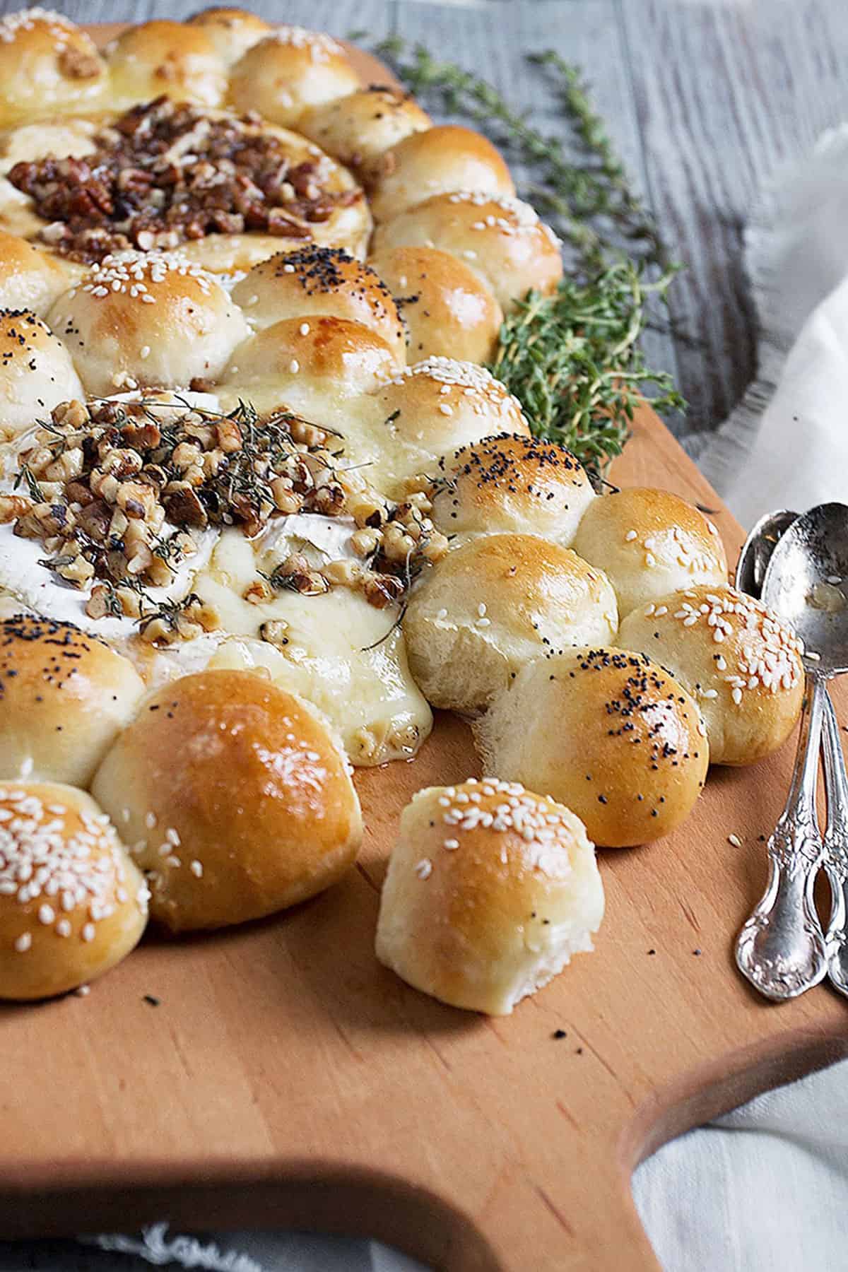 bread bites with baked brie on cutting board