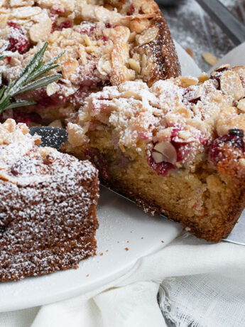 cranberry coffee cake sliced on cake plate