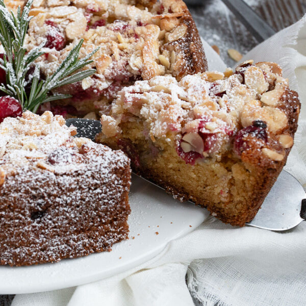 cranberry coffee cake sliced on cake plate