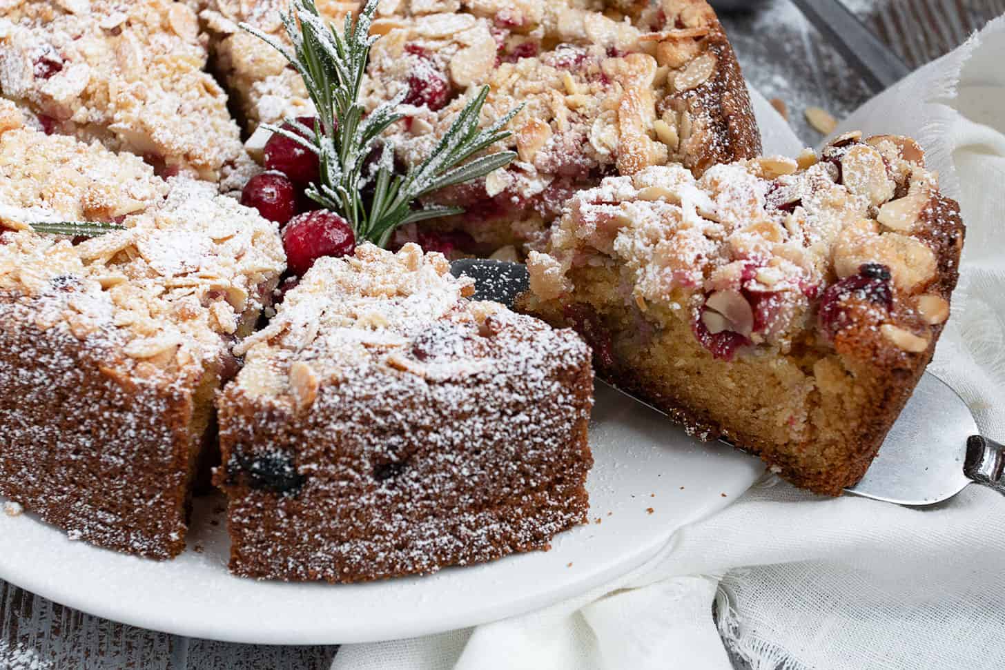 cranberry coffee cake sliced on cake plate