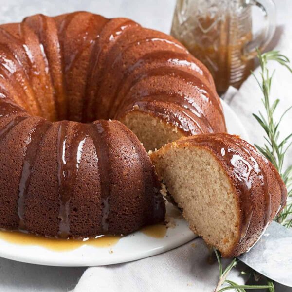 Ginger bundt cake sliced with brown sugar sauce