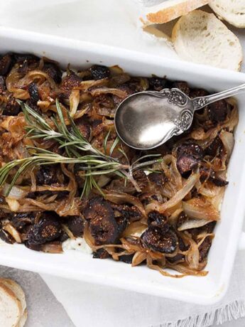 fig onion and goat cheese dip in white dish with spoon