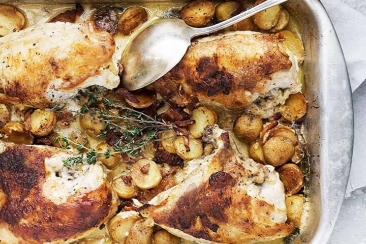 honey mustard chicken in baking dish with potatoes and bacon