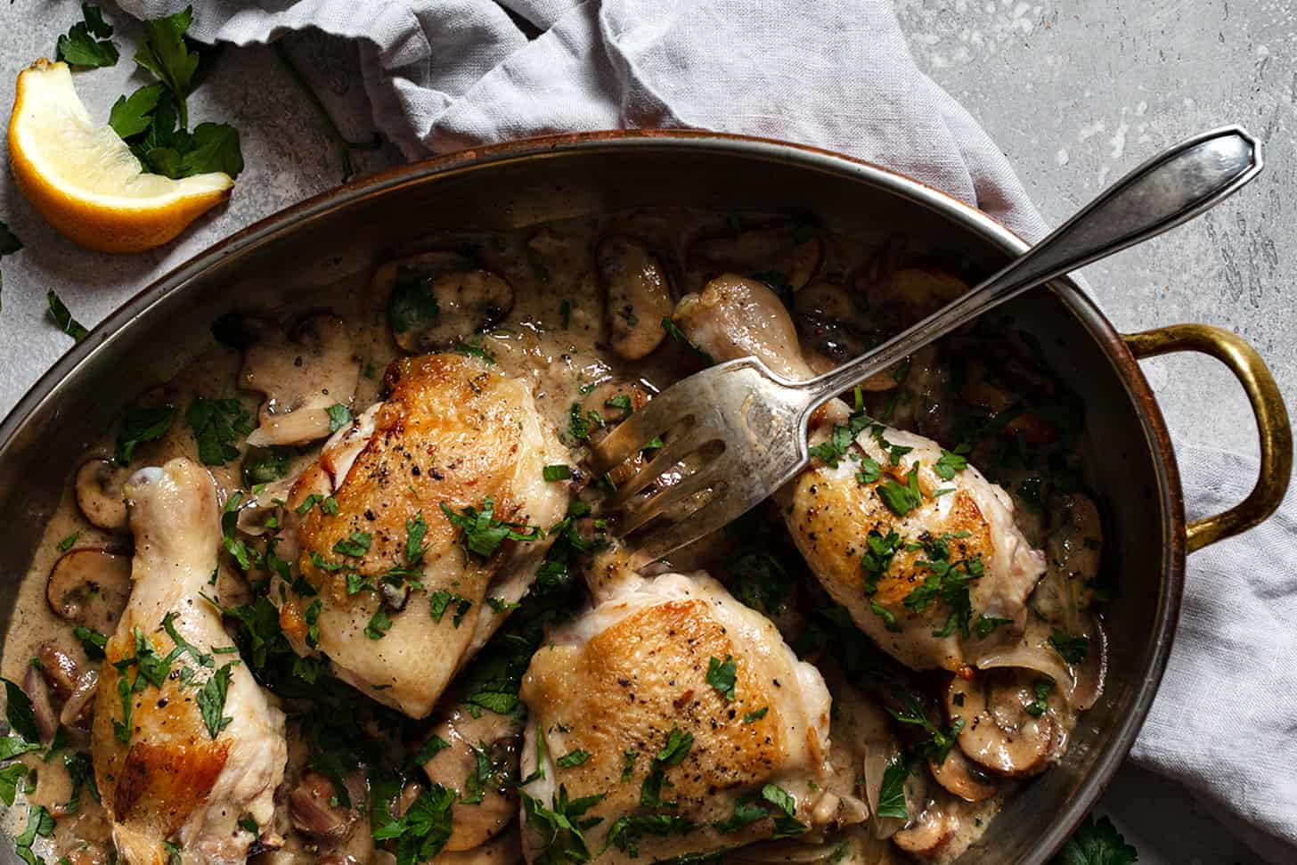 chicken riesling in pan with fork