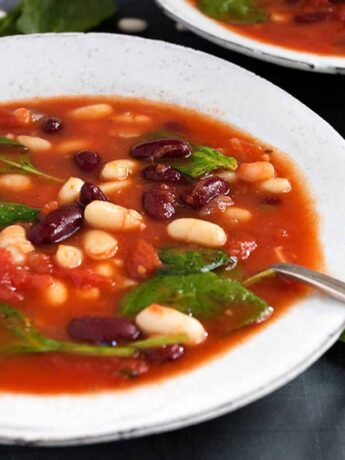 tomato bean soup with spinach in bowls